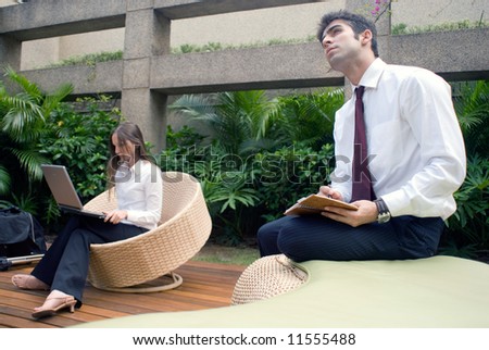 Man and woman working together in an outdoor courtyard