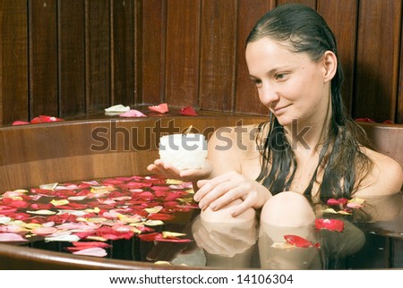 Woman looking at a candle with a neutral expression