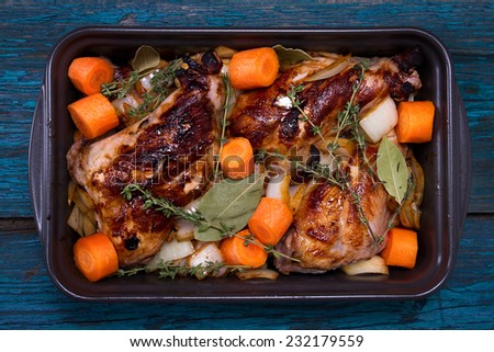 Fried rabbit\'s foot with thyme, onion, celery and carrots in a flameproof casserole dish