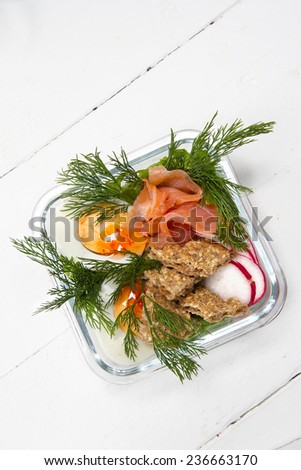 Kids lunch box: salted salmon, egg, radish, rye bread and dill