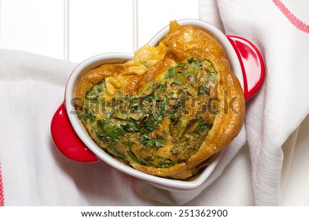 Parsley and garlic frittata in a heart shaped baking form