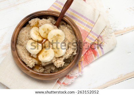 Healthy breakfast: oat bran porridge, banana and agave syrup