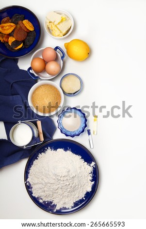 Traditional Russian Easter cake ingredients: flour, yeast, sugar, lemon, milk, eggs, butter, dried fruits, marzipan, vanilla and rum extract