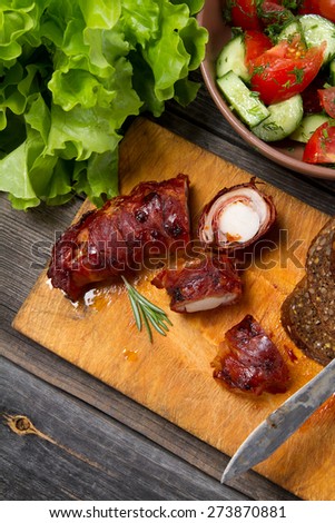Roasted saddle of rabbit wrapped in bacon, lettuce, tomatoes, cucumbers, dill and whole wheat bread