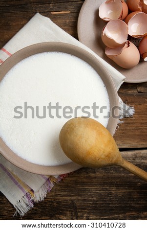 Russian traditional pancakes - bliny - batter: eggs, flour, sour milk, salt and sugar