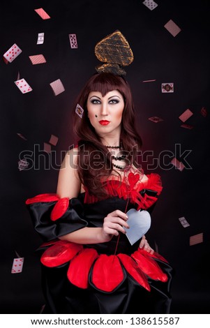portait of a queen of spades with cards on the black background