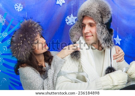 Happy family in winter hat, gloves and sweater in studio.