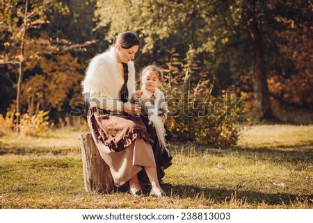 Mother and her daughter in vintage clothes
