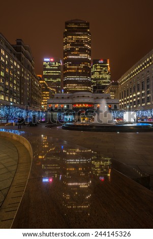 LONDON, UK - JANUARY 11th 2015:A night view of Cabot Square in Docklands, London, UK. The square includes a fountain and several works of art. On the east side of the square is a large shopping centre