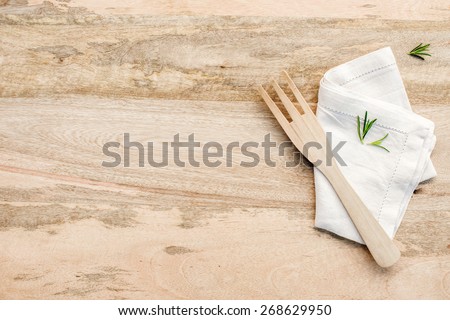 Wooden kitchen table from above with copy space. rosemary on wood table. kitchen photo for recipe book or advertisement.