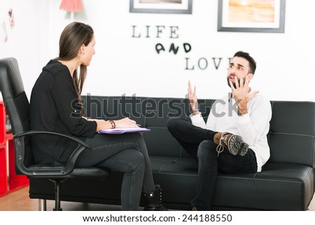 Female psychologist consulting mature man during psychological therapy session