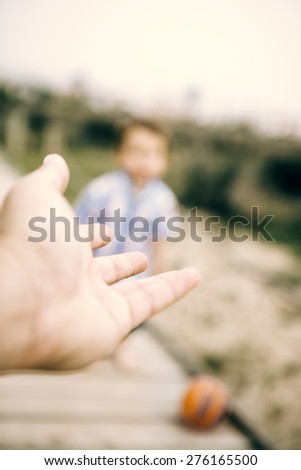 Father offering hand to his son at outdoors