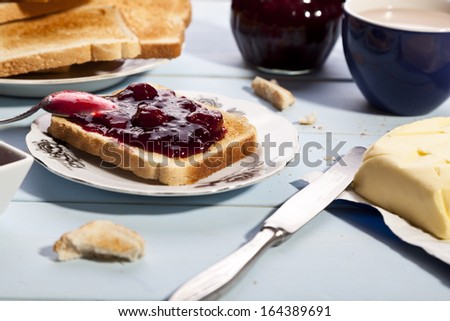 Breakfast with bread toast with cherry jam and a cup of cocoa