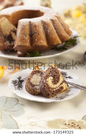 Easter marble ring cake with a cap of coffee - focus on a piece of cake