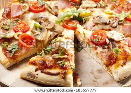 Pizza with ham and mushrooms on plate