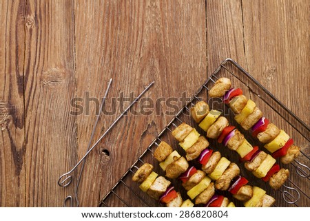 Grilled chicken skewers with pineapple, peppers and onions