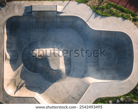 Similar – Image, Stock Photo Skater performing trick on ramp in skate park