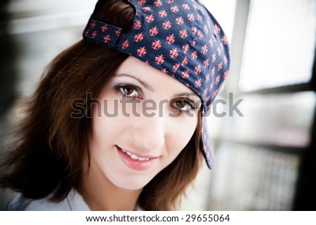 Dark Haired Girl With Baseball Cap. Close-Up Portrait