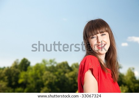 Smiling Beauty Woman Against Blue Sky
