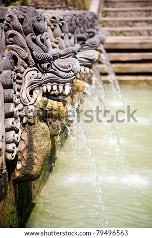 Thermal water  is released from the mouth of statues at a hot springs in Banjar, Bali, Indonesia