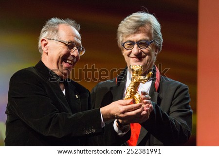 BERLIN, GERMANY - FEBRUARY 12: Dieter Kosslick presents the Honorary Golden Bear to Wim Wenders.  65th Berlin International Film Festival at Berlinale Palace on February 12, 2015 in Berlin, Germany.