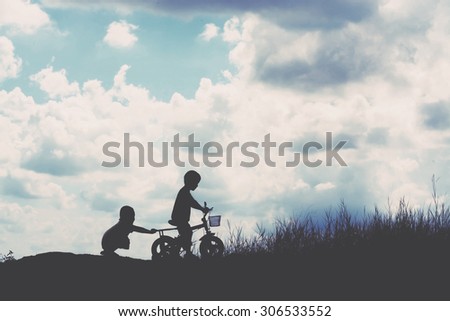 two little boys bike silhouette