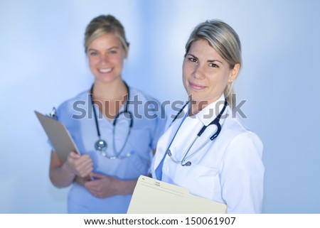 Two happy health care professionals looking at the camera