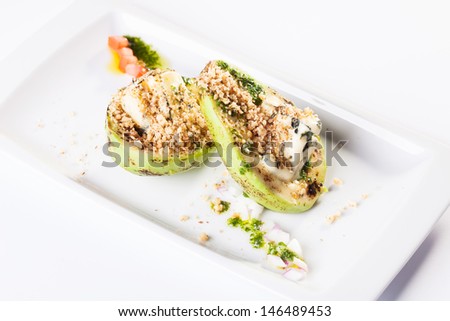 Grilled avocado with blue cheese and nuts