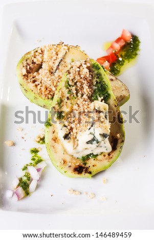 Grilled avocado with blue cheese and nuts