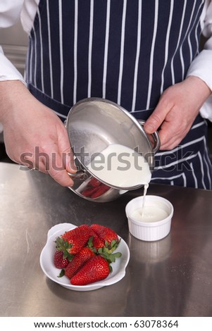 Chef pouring milk in a cup