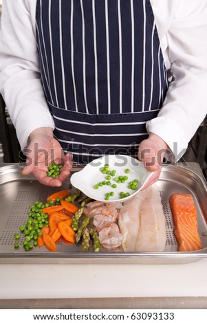 Chef add peas into the baking dish