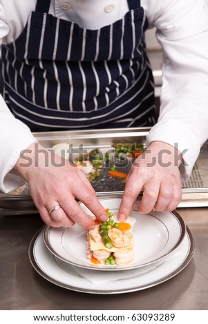 Chef cooking seafood lasagna