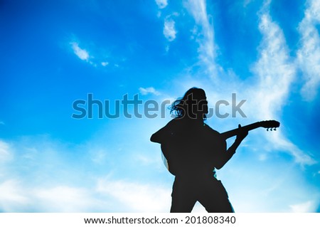 guitarist in a scenic blue sky