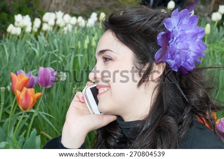 beautiful smile of a girl on the phone in a beautiful day