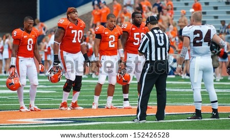 CHAMPAIGN,IL-AUGUST 31: Illinois Fighting Illini and SIU Salukis meet at the 50 yard line for the coin toss before the game on Saturday, Aug 31, 2013.