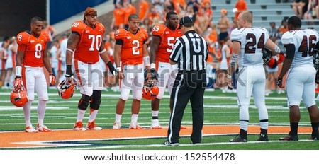 CHAMPAIGN,IL-AUGUST 31: UI and SIU participate in the coin toss just prior to the game on Saturday, Aug 31, 2013.