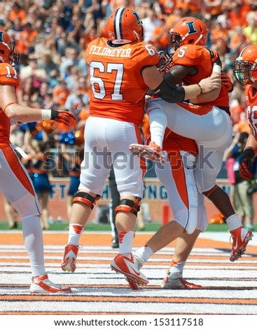 CHAMPAIGN,IL-AUGUST 31: Illinois running back Donovonn Young (5) jumps into his teammates arms after scoring a touchdown during the second quarter of a game against SIU on Saturday, Aug 31, 2013.