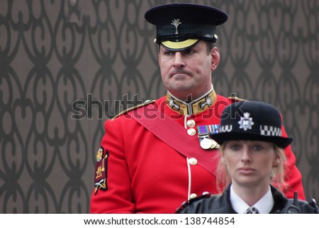 LONDON - APRIL 17: A soldier and policewoman oversee Margaret Thatcher\'s funeral procession on April 17, 2013 in London.