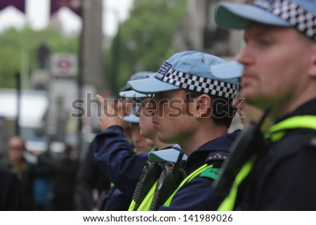 LONDON - June 12: Police officers watch an anti-weapon industry demonstration in the West End on June 12, 2013 in London.