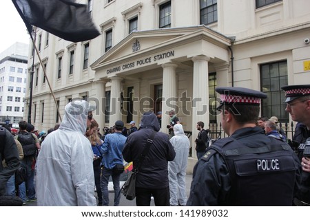 LONDON - June 12: Police officers watch anti-arms industry protestors demonstrate outside the Charing Cross Police Station, in Charing Cross on June 12, 2013 in London.