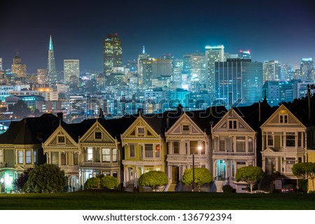 all colors of city lights turn up after the Victorian style houses with a modern city background.