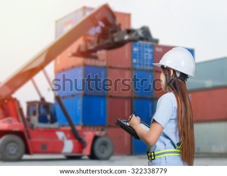 Employees in logistics company shipping containers with tablet