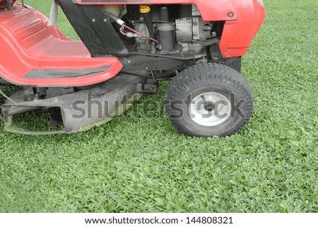 lawn mower on fresh cut grass in the garden