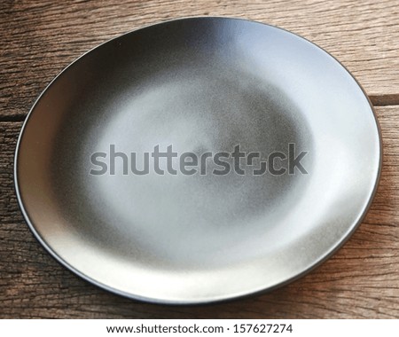 black blank dish on wood