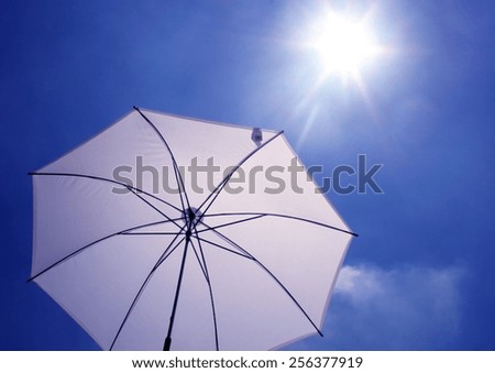 sun umbrella in blue sky with sunny shine