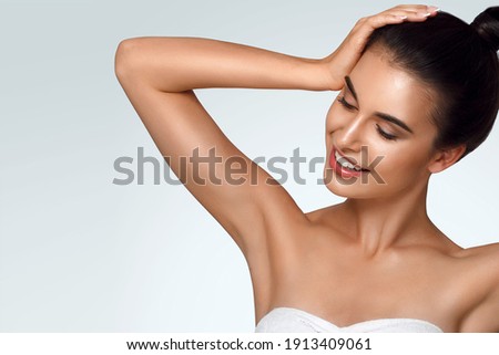 Caucasian beautiful girl holds hair in hand, raise up hands. Beauty young woman, salon body and armpit skin care, smooth armpit skin, hair removal and sugaring. Happy girl with closed eyes 商業照片 © 