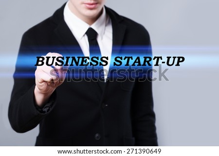 business, technology and internet concept - businessman is writing business start-up text