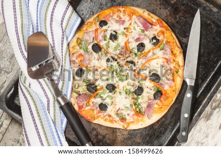 Homemade pizza on baking tray and Ingredients for cooking. From the series \