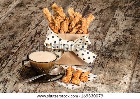 Garlic cheese bread sticks and cup of black tea with milk From series Homemade bread