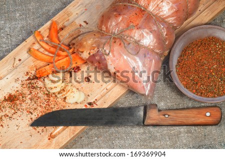 Raw pork roll package for roasting on wooden chopping board From series ?ooking meat